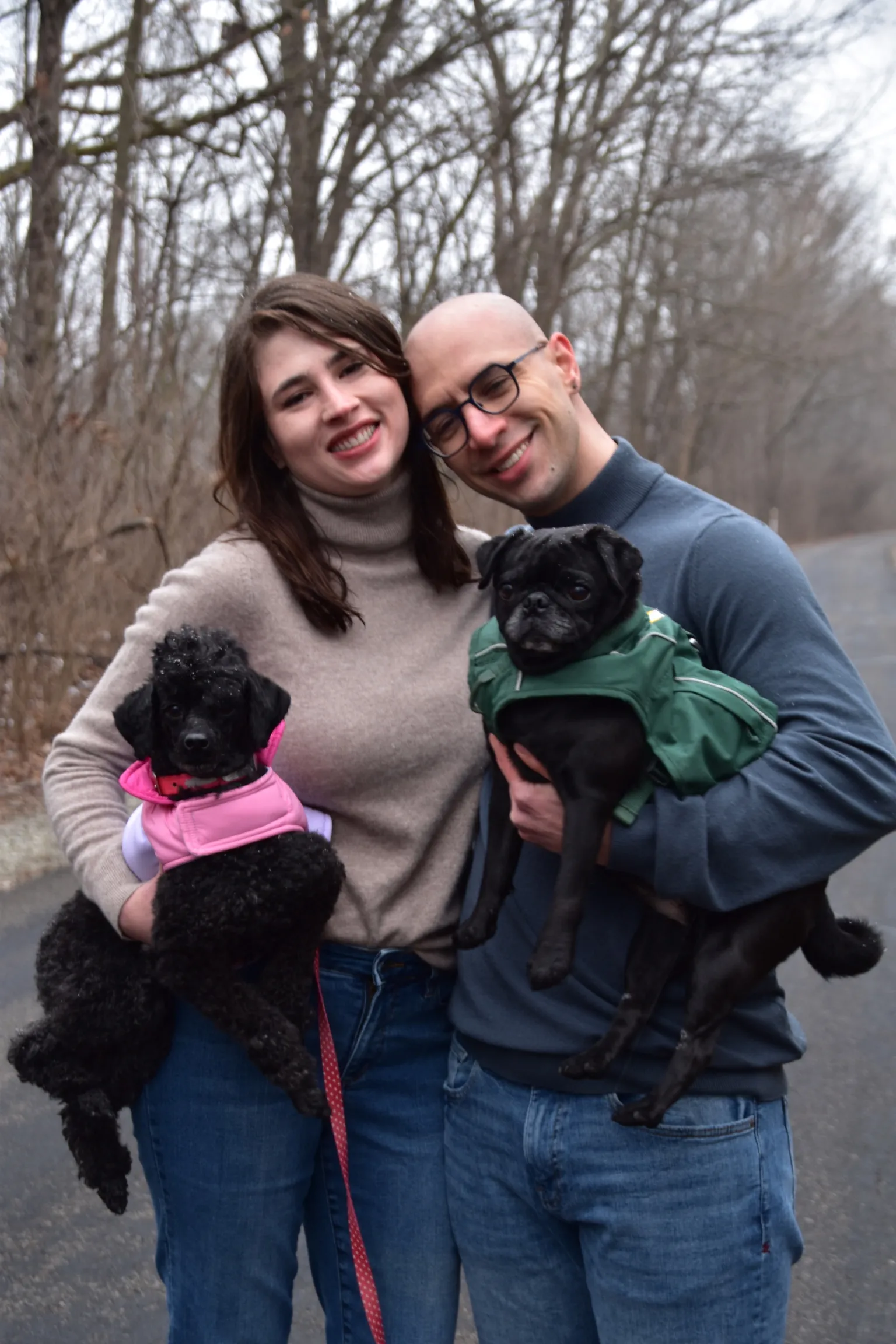 Jared and Caeli holding their dogs